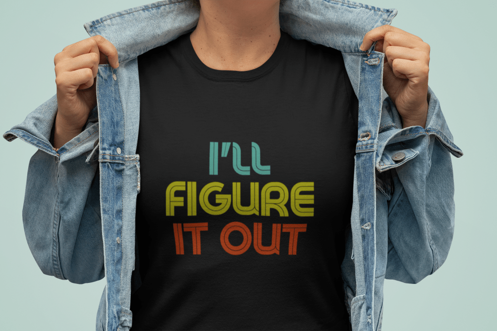 picture of a woman wearing an I'll Figure It Out retro font style sweatshirt under a denim jacket