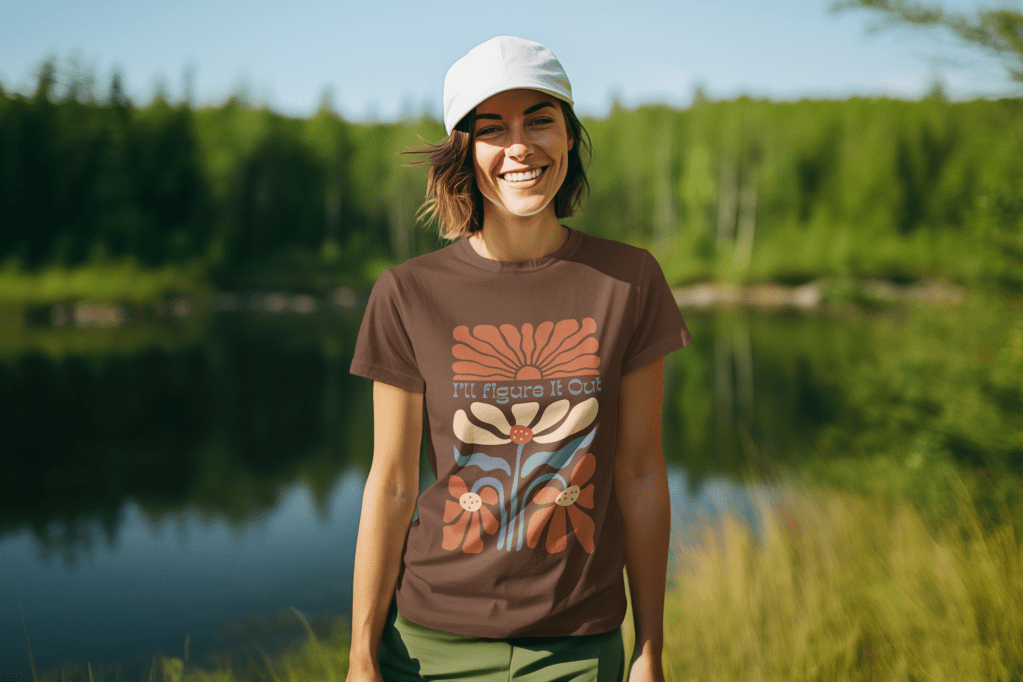 woman standing by a lake in the outdoor wearing a retro groovy flower pattern with I'll Figure It Out in a complimentary font