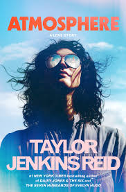 The book cover of Atmosphere - woman with long brown hair looking up to the sky with mirrored sunglasses.