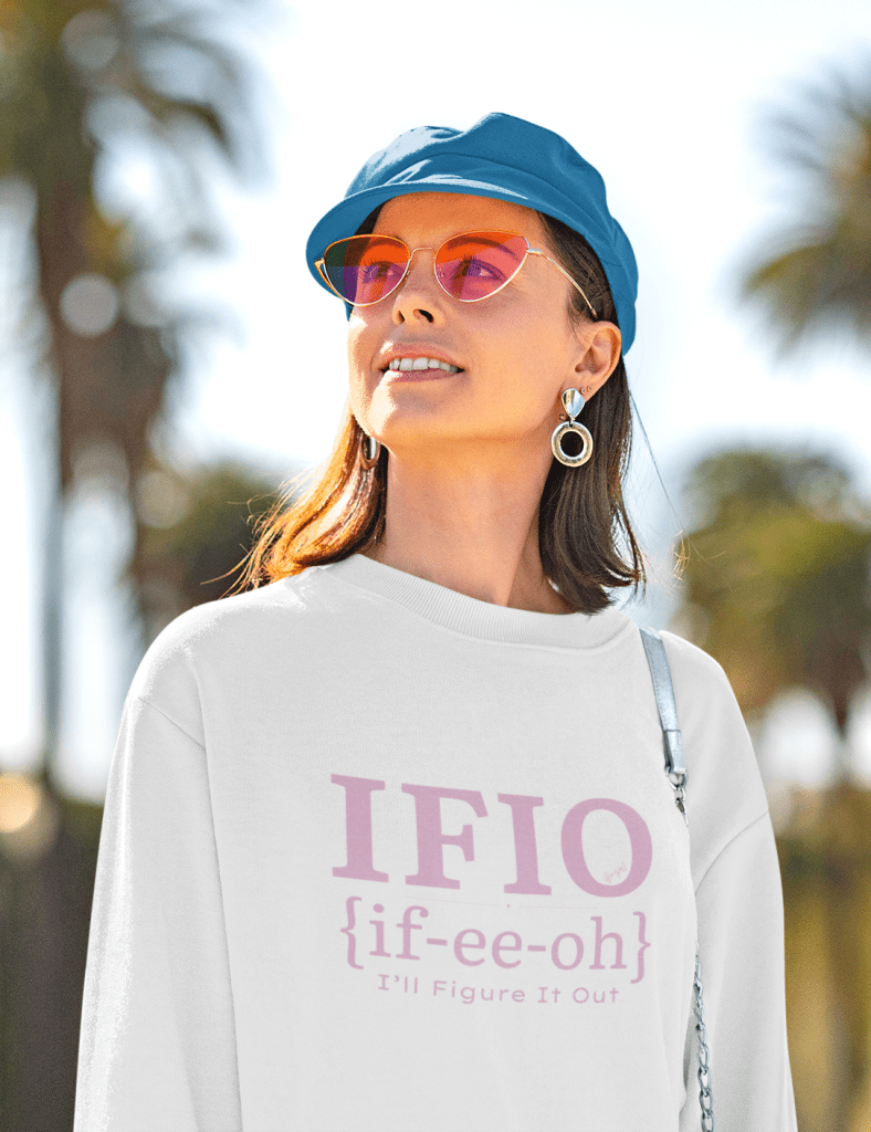 woman wearing sunglasses, hat and IFIO white sweatshirt that has the pronunciation of IFIO if-ee-oh